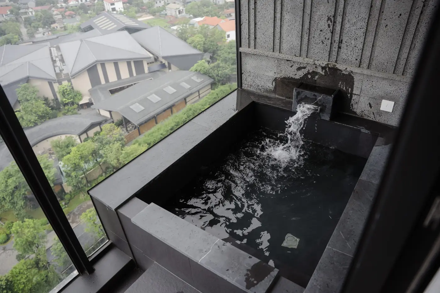 Bồn onsen đá đen riêng bên cửa kính nhìn xuống khu Ohayo Onsen – Lynntimes Thanh Thủy